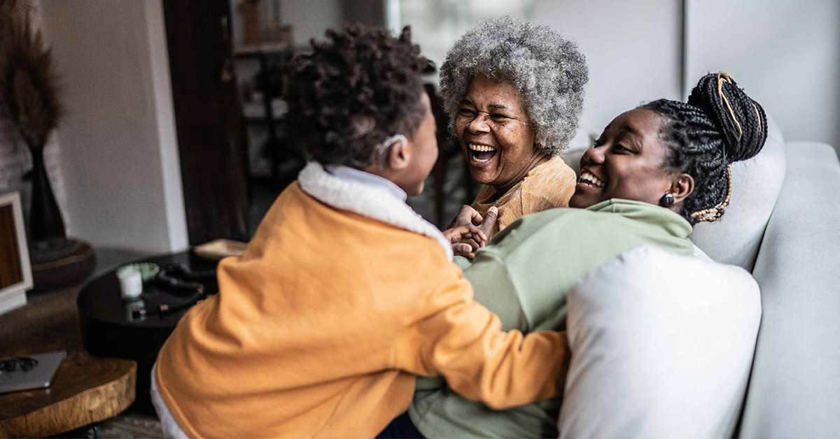 Three generations laughing together.